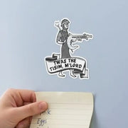 A hand is sticking a note on a refrigerator, which has a sticker of a cartoon character and text on it.